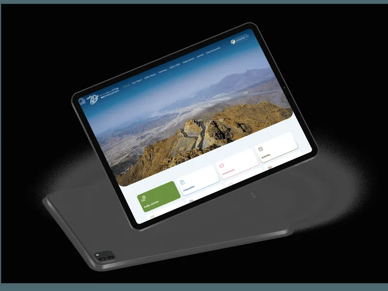 The WAJ Development site on a tablet, showing a full-width landscape hero above three cards.